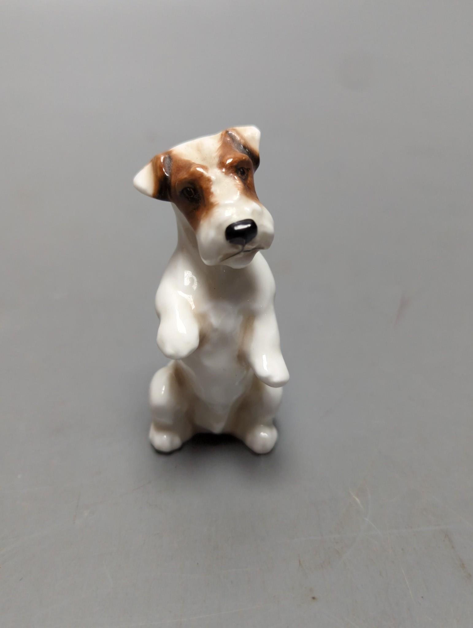 A large Royal Doulton figure of a seated Labrador (No. 2314), height 34cm, a small Beswick Airedale Terrier and another (3)